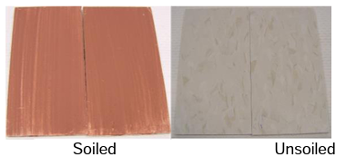 A soiled tile (left) after it was removed from the oven vs. an unsoiled tile (right)